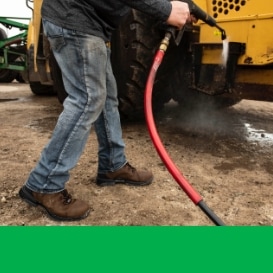 Person washing a piece of equipment.